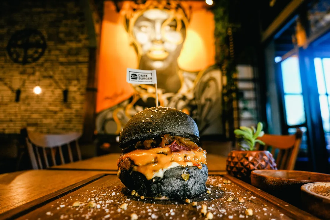 Black-bun Dark Burger with our flag, in front of the graffiti wall in our Başakşehir restaurant