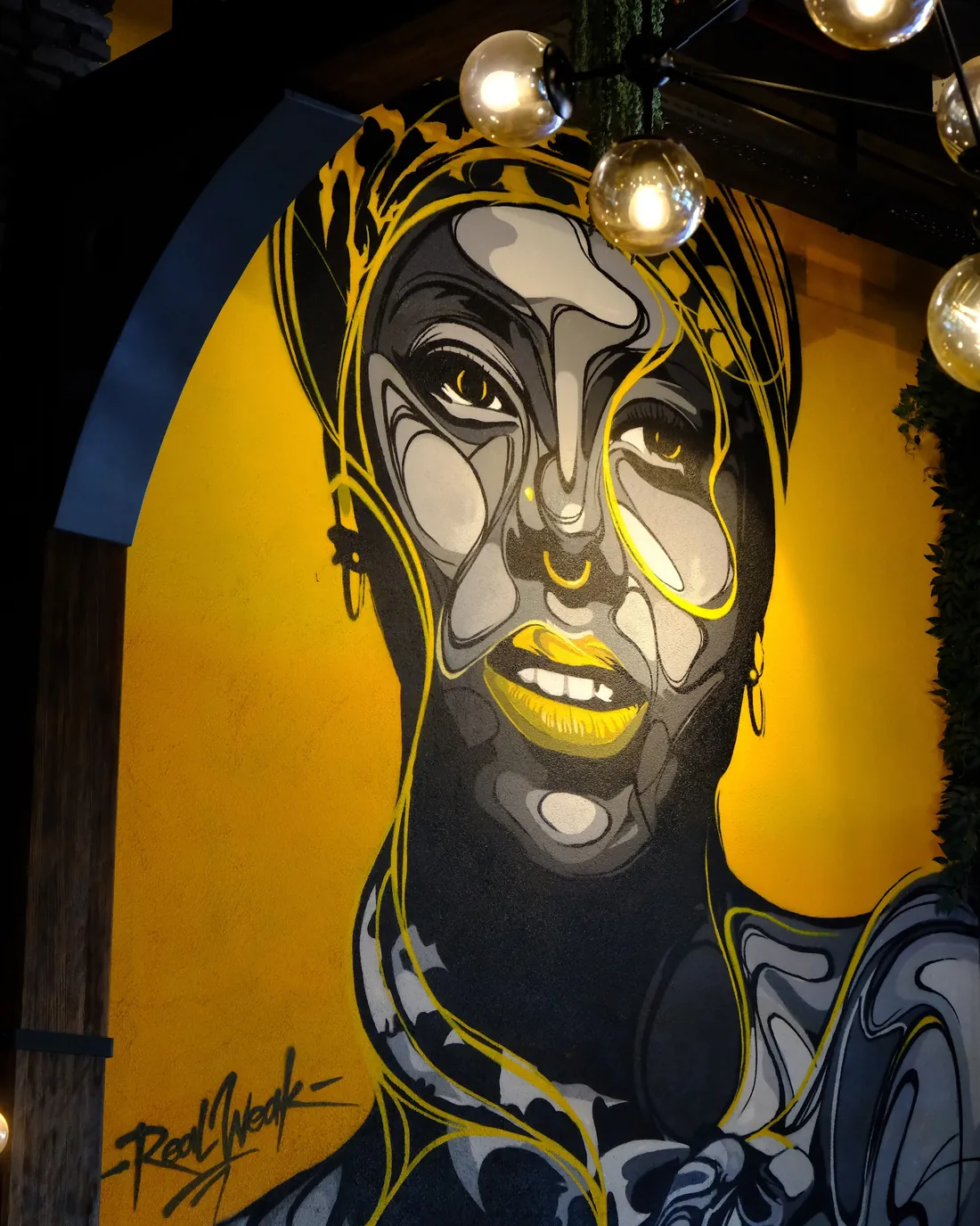 The large portrait mural and globe lights in our dining room